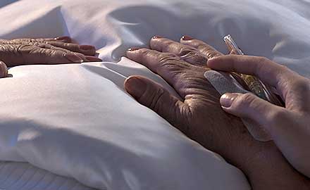 hands of person in bed