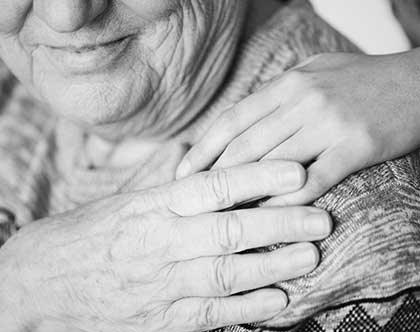 Hand on elderly persons shoulder