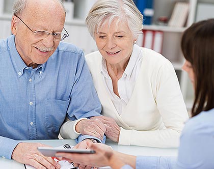 Elderly couple meeting with planner